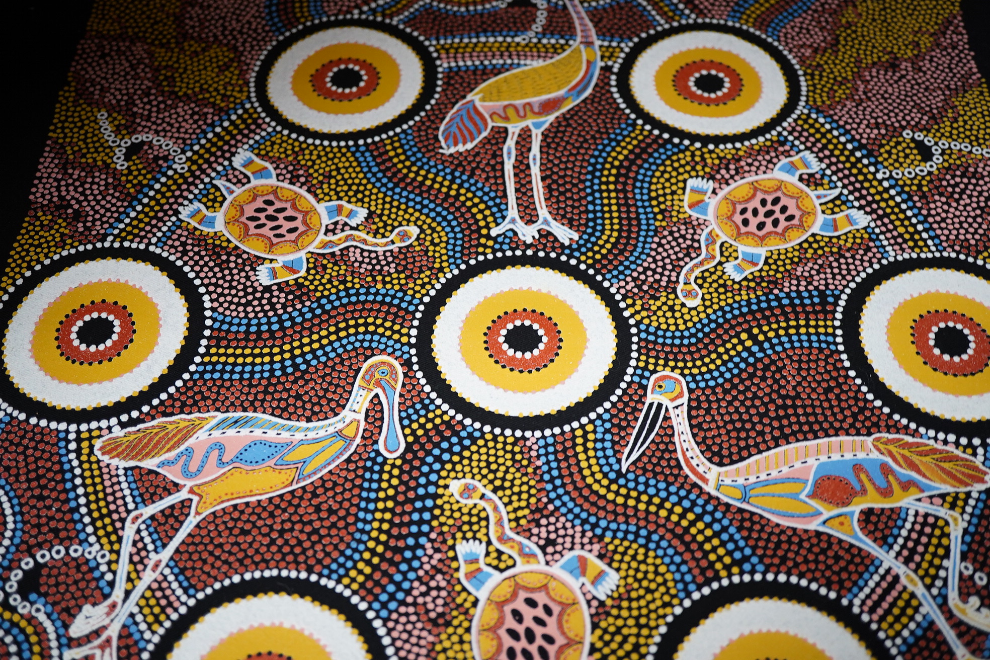 An Aboriginal painted wooden shield and a dot painted scroll